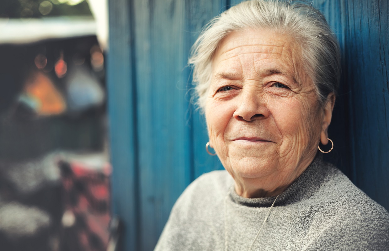 Happy old senior woman smiling outdoor portrait